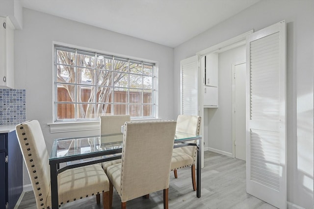 dining space with light wood-type flooring