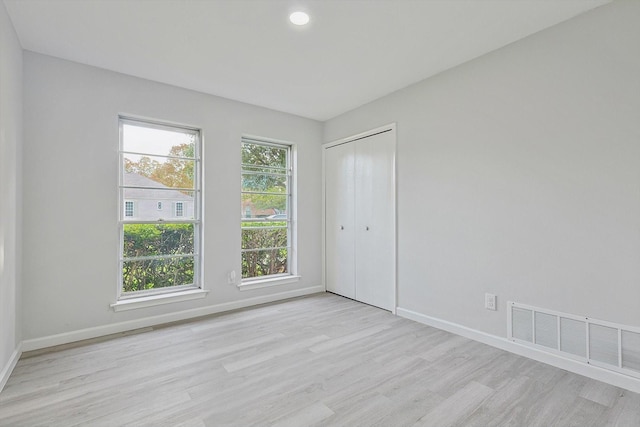 spare room featuring light wood-type flooring