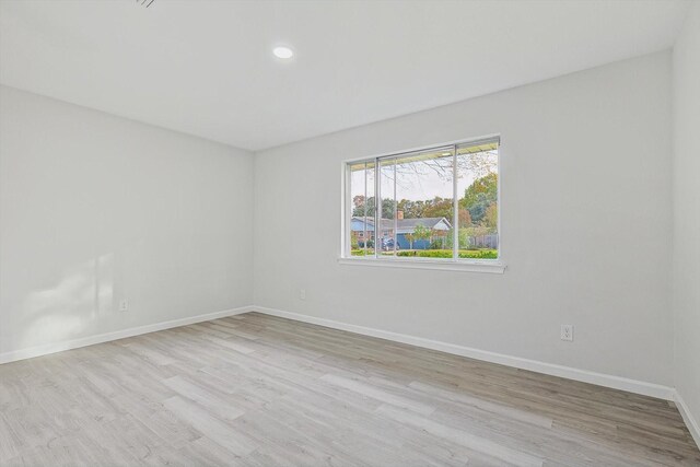 unfurnished room with light hardwood / wood-style floors