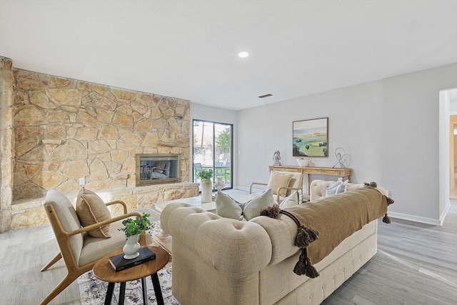 living room featuring hardwood / wood-style floors and a fireplace