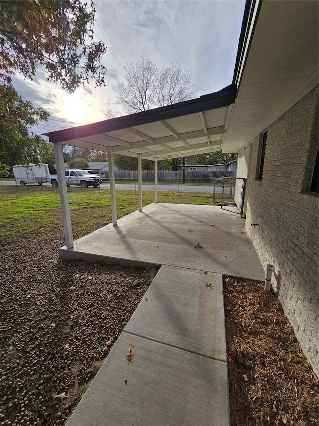 parking at dusk with a carport and a lawn