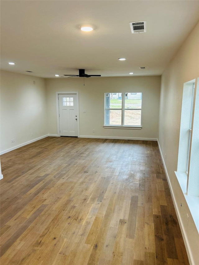 interior space featuring hardwood / wood-style flooring, a wealth of natural light, and ceiling fan