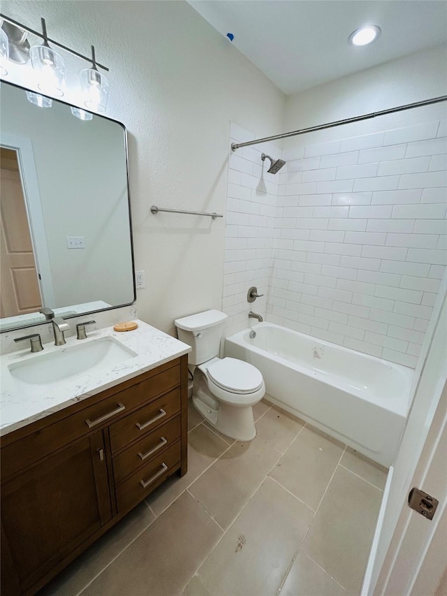 full bathroom with vanity, tile patterned flooring, toilet, and tiled shower / bath