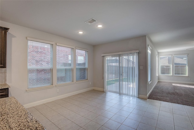 interior space with a wealth of natural light and light tile patterned floors