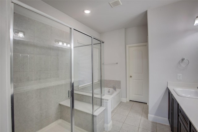 bathroom featuring shower with separate bathtub, tile patterned floors, and vanity