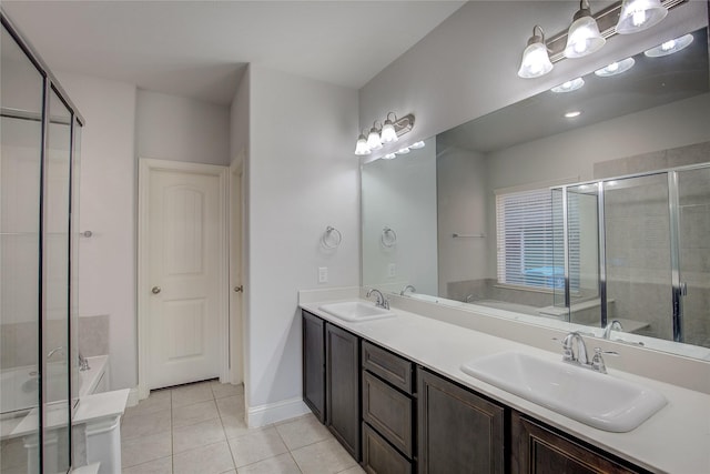 bathroom featuring tile patterned floors, separate shower and tub, and vanity