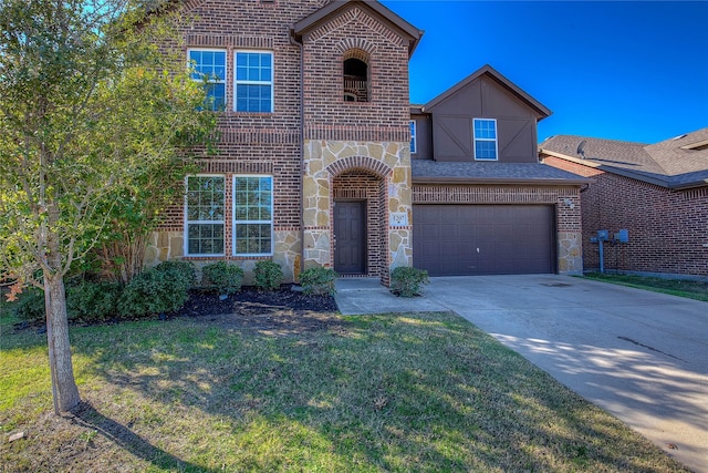 view of front of home with a garage and a front lawn