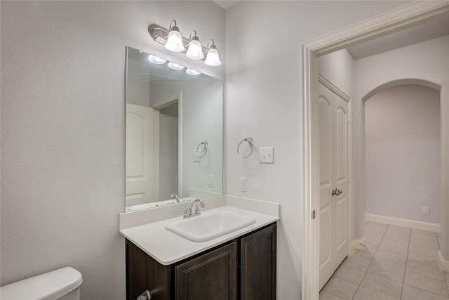 bathroom with vanity, tile patterned floors, and toilet