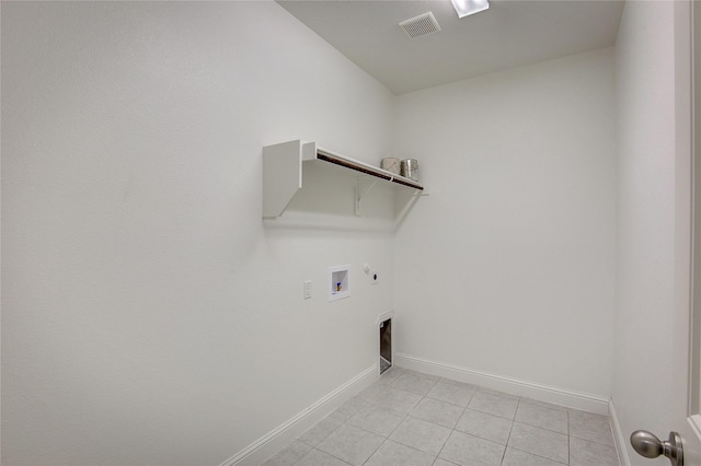 laundry area with gas dryer hookup, hookup for an electric dryer, washer hookup, and light tile patterned floors