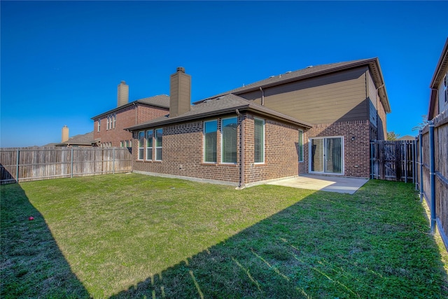 back of house featuring a yard and a patio area