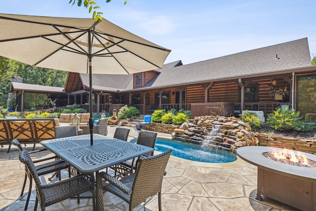 view of swimming pool with a fire pit and a patio