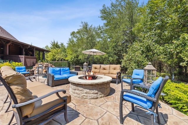 view of patio / terrace with an outdoor living space with a fire pit