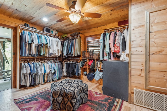 walk in closet with ceiling fan and wood-type flooring