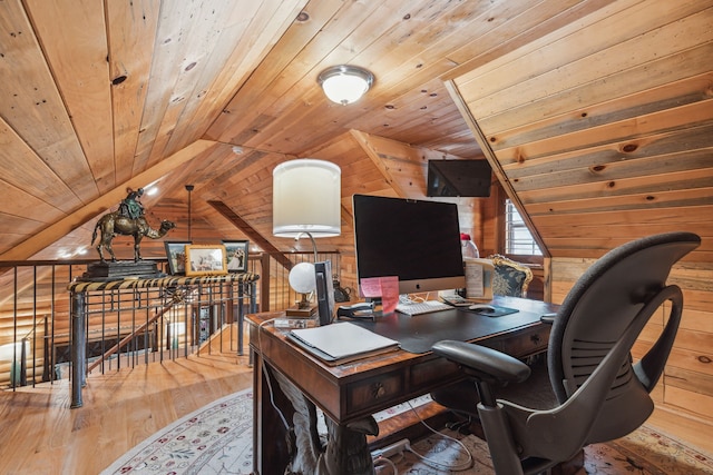 office space featuring wood walls, wood ceiling, light hardwood / wood-style flooring, and vaulted ceiling