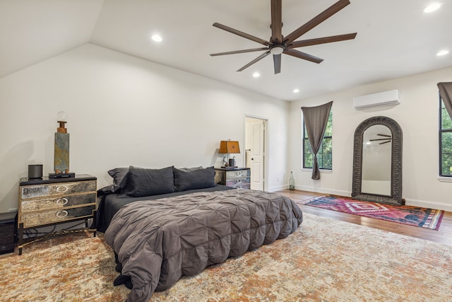 bedroom with a wall mounted AC, ceiling fan, hardwood / wood-style floors, and lofted ceiling