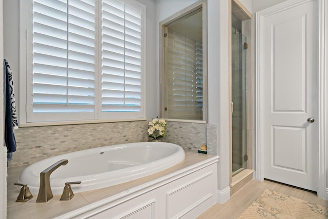 bathroom with separate shower and tub and hardwood / wood-style floors