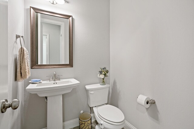 bathroom featuring toilet and sink