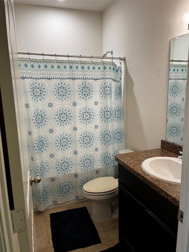 bathroom with vanity, tile patterned floors, and toilet