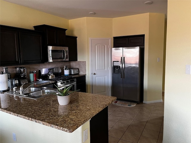 kitchen featuring tasteful backsplash, stainless steel appliances, sink, and light tile patterned floors