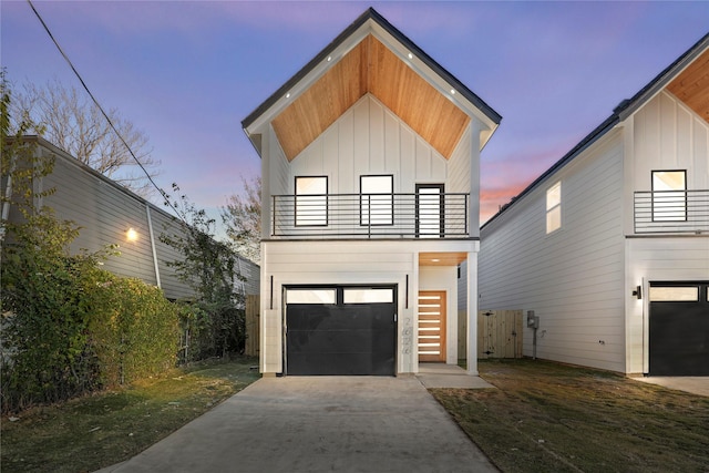 contemporary home featuring a garage and a balcony