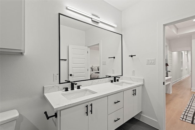 bathroom featuring hardwood / wood-style flooring, vanity, and toilet