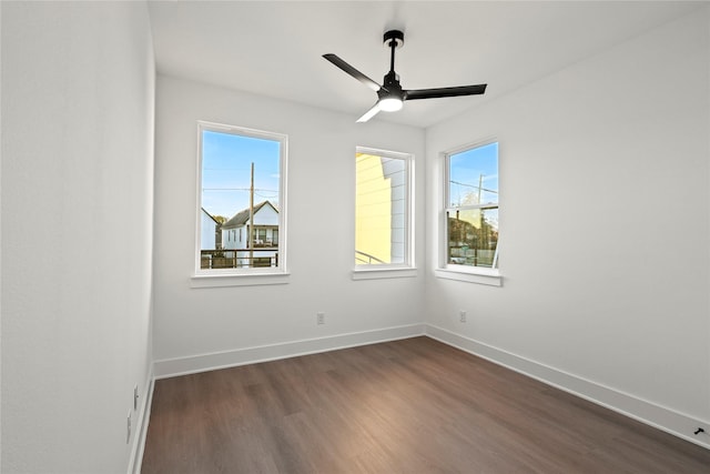 spare room featuring ceiling fan and dark wood-type flooring