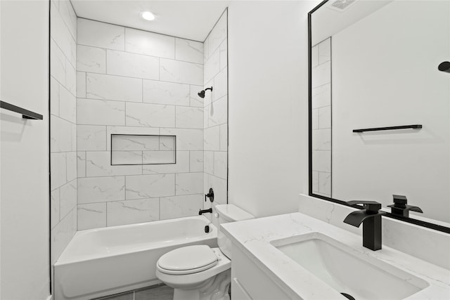 full bathroom featuring tiled shower / bath combo, toilet, and vanity