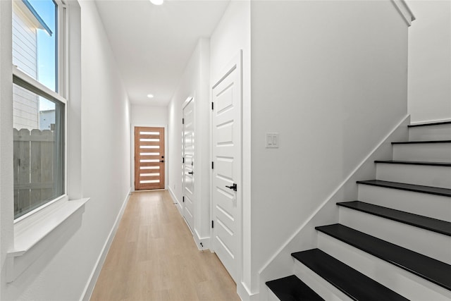 hall featuring light hardwood / wood-style floors and a wealth of natural light