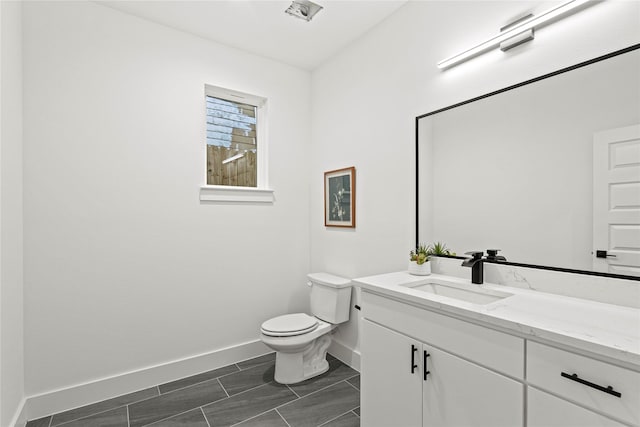 bathroom with tile patterned floors, vanity, and toilet