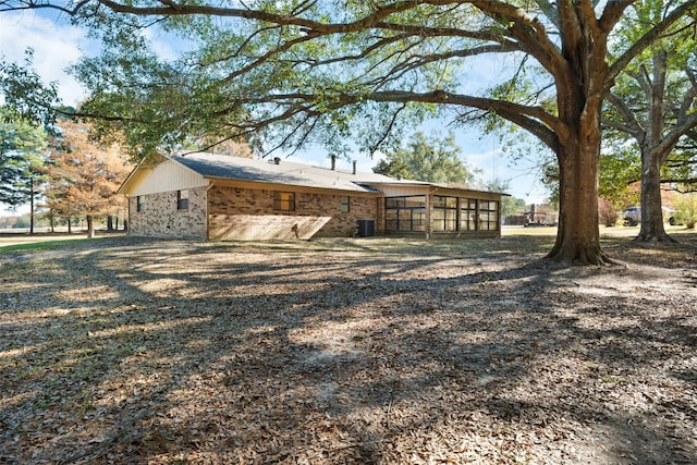 view of home's exterior with a sunroom