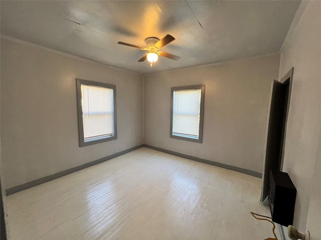 unfurnished room featuring ceiling fan, ornamental molding, and light hardwood / wood-style floors