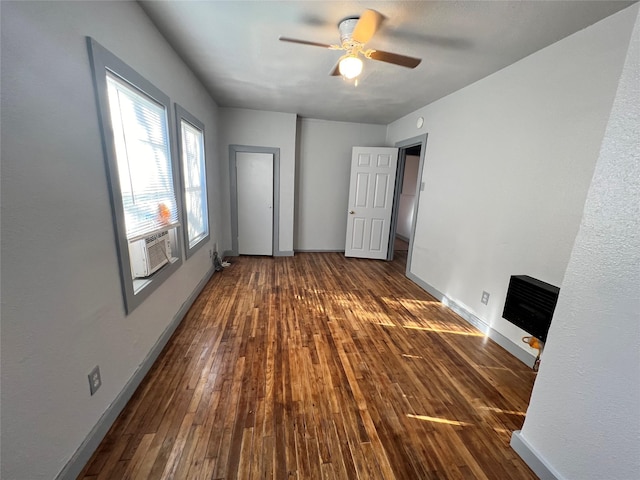 interior space featuring dark hardwood / wood-style floors, cooling unit, and ceiling fan