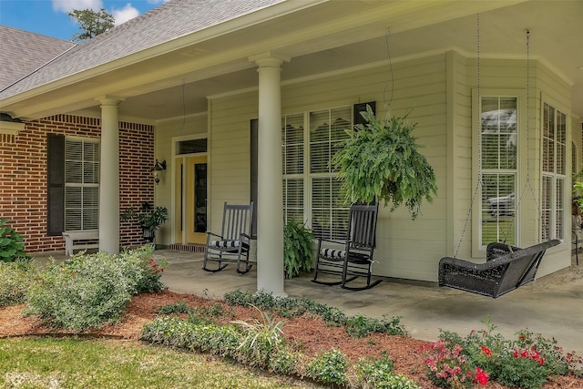 view of exterior entry featuring covered porch