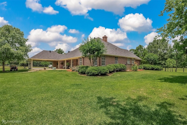 rear view of house featuring a yard and a patio area