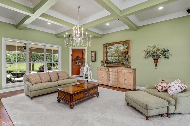 living room with wood-type flooring, beam ceiling, coffered ceiling, crown molding, and an inviting chandelier