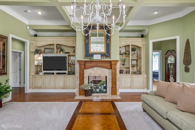 living room with hardwood / wood-style flooring, a premium fireplace, coffered ceiling, and a chandelier