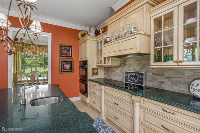 kitchen featuring decorative light fixtures, sink, a chandelier, black appliances, and cream cabinets