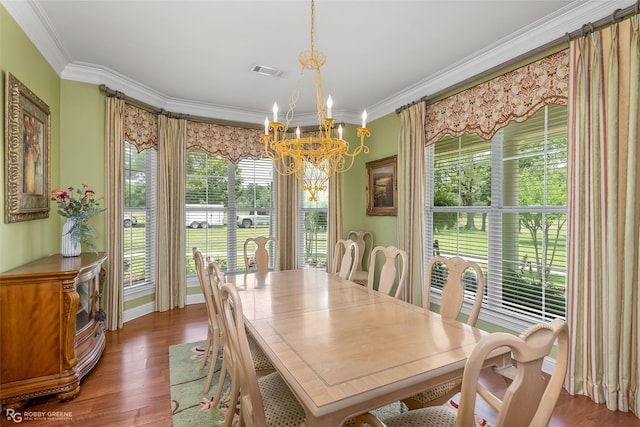 dining area with crown molding, dark hardwood / wood-style flooring, and a chandelier