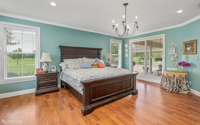 bedroom featuring crown molding, access to exterior, an inviting chandelier, and light hardwood / wood-style flooring