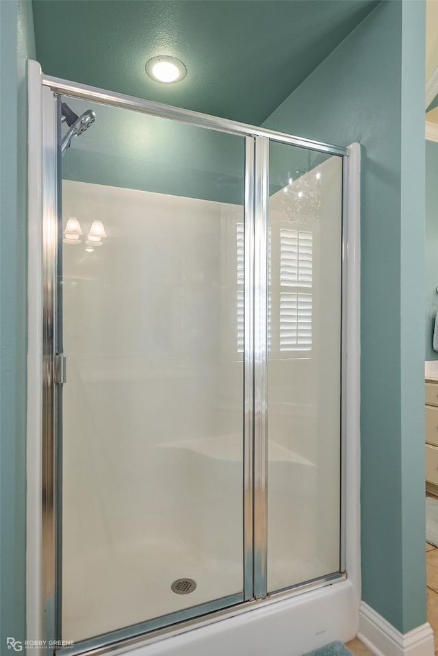 bathroom with a shower with door