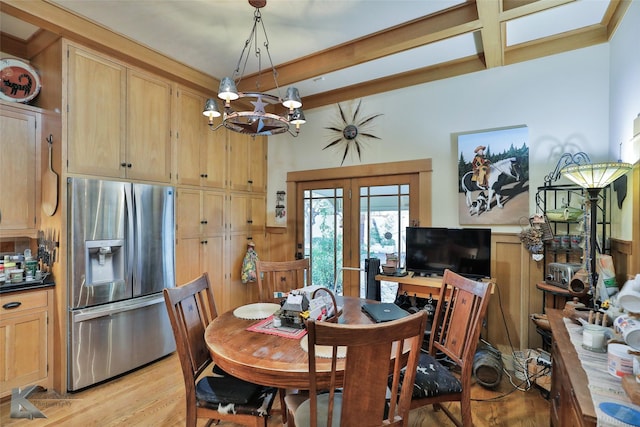 dining space with beam ceiling, light wood-type flooring, and an inviting chandelier