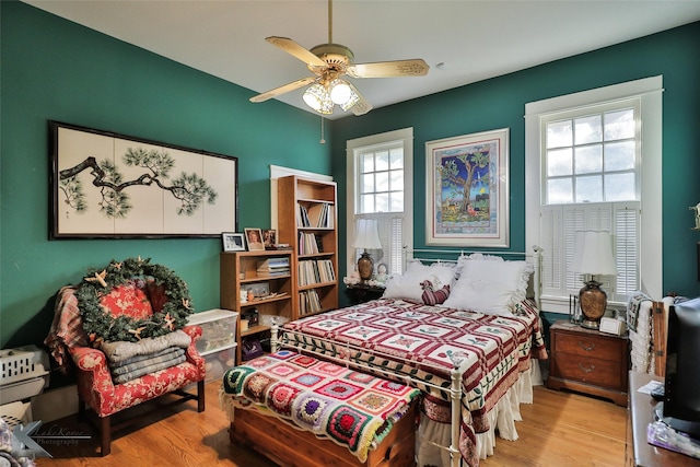 bedroom with light hardwood / wood-style flooring and ceiling fan