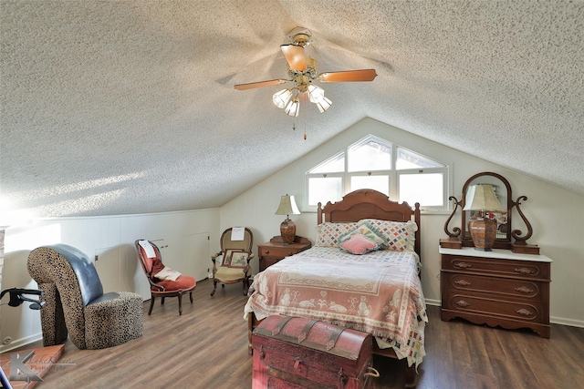 bedroom with ceiling fan, dark wood-type flooring, and a textured ceiling