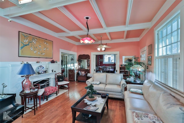 living room with hardwood / wood-style flooring, ceiling fan, coffered ceiling, and beam ceiling