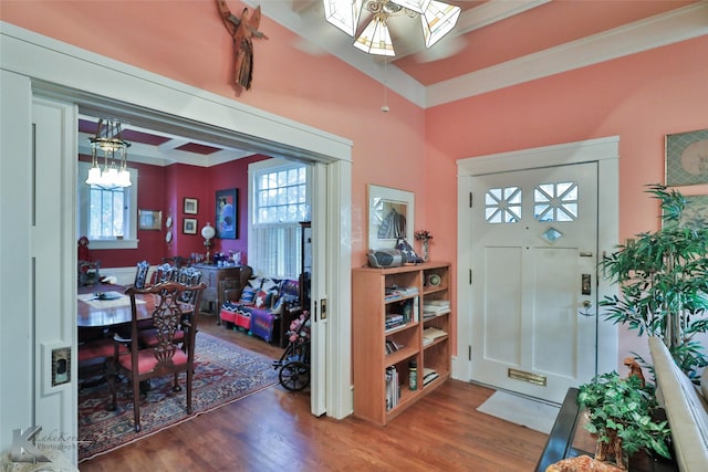 foyer with dark hardwood / wood-style flooring and ornamental molding