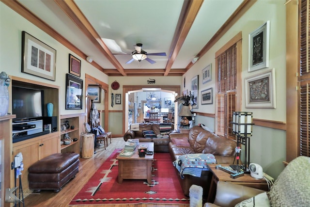 living room with coffered ceiling, hardwood / wood-style floors, beam ceiling, and ceiling fan