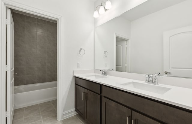 bathroom with tiled shower / bath, tile patterned floors, and vanity