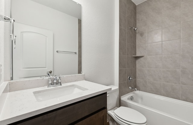 full bathroom featuring tiled shower / bath, vanity, and toilet