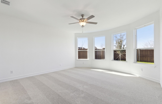 spare room featuring ceiling fan and light colored carpet