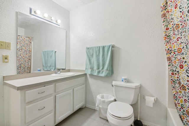 bathroom with tile patterned flooring, vanity, and toilet